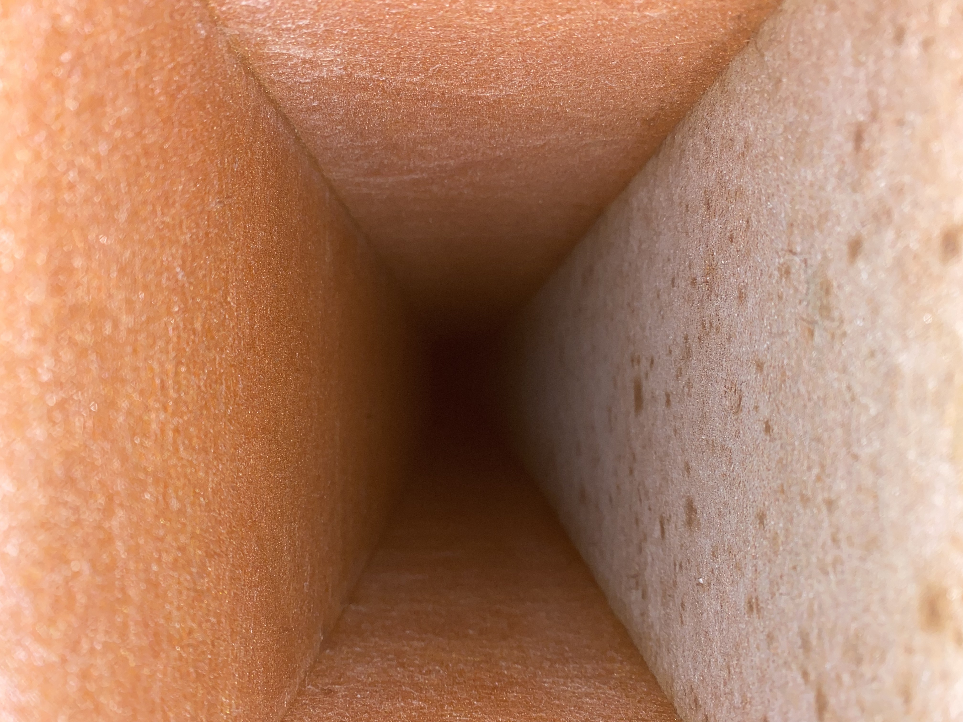 Lined duct coated in orange dust before cleaning, Golden Gate, FL